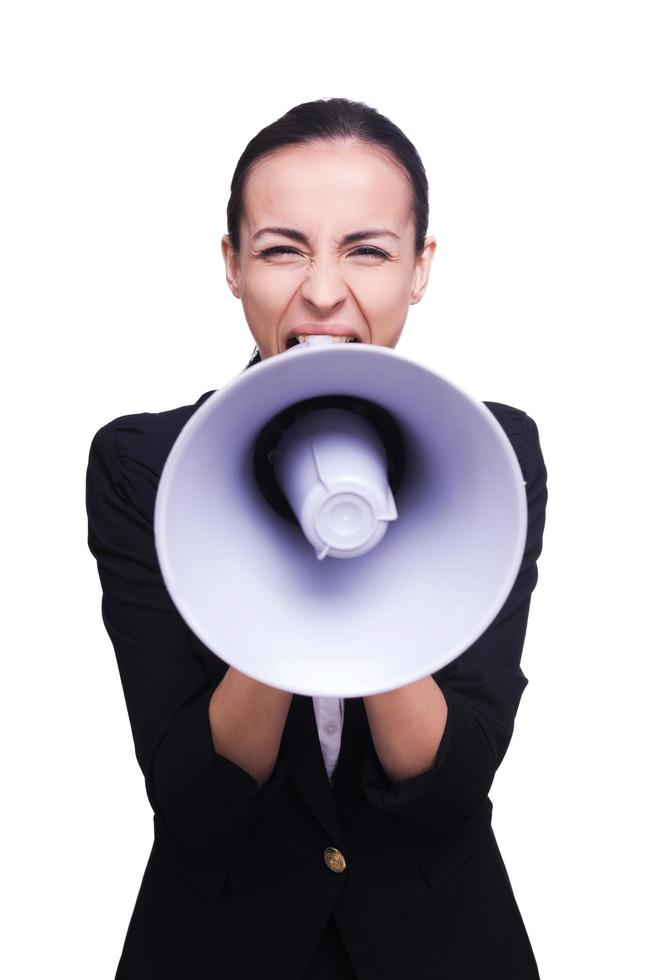 Hearing her loud and clear. Portrait of furious young businesswoman shouting on a megaphone photo