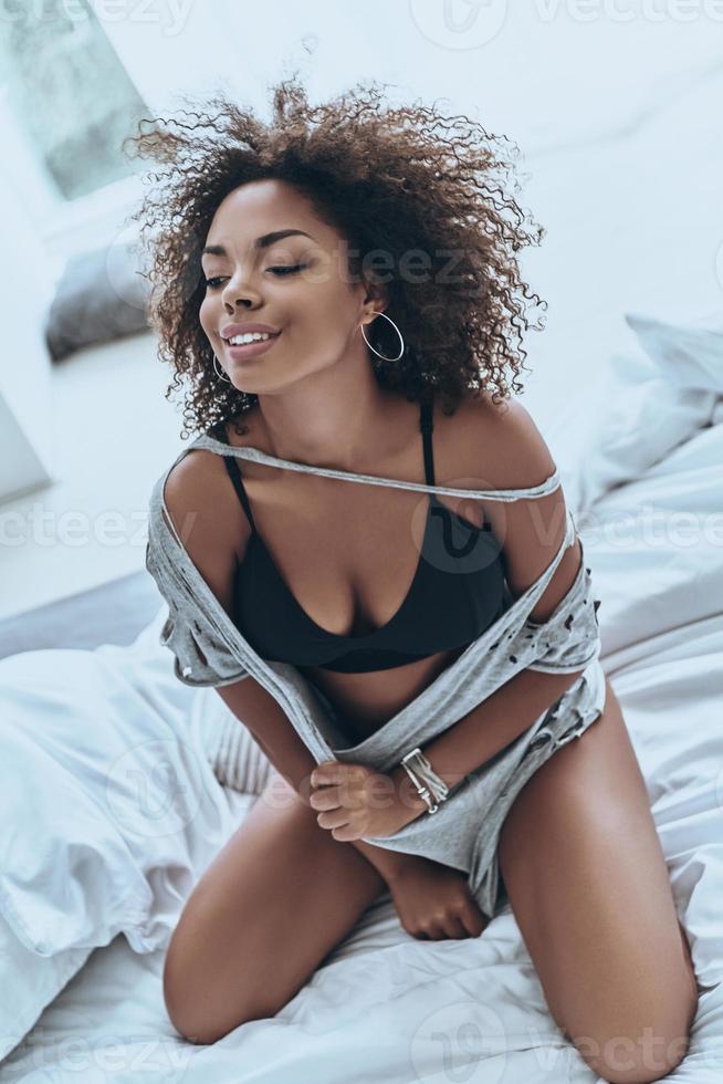 Calm and relaxed. Attractive young African woman in black lingerie