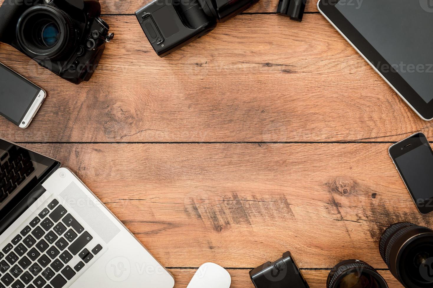 Copy space for something special. Top view of diverse equipment for photographer laying on the wooden grain photo