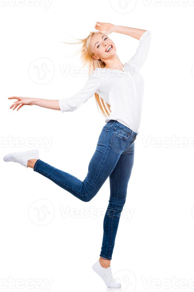 Flying beauty. Full length of beautiful mature women posing and smiling while standing against white background photo