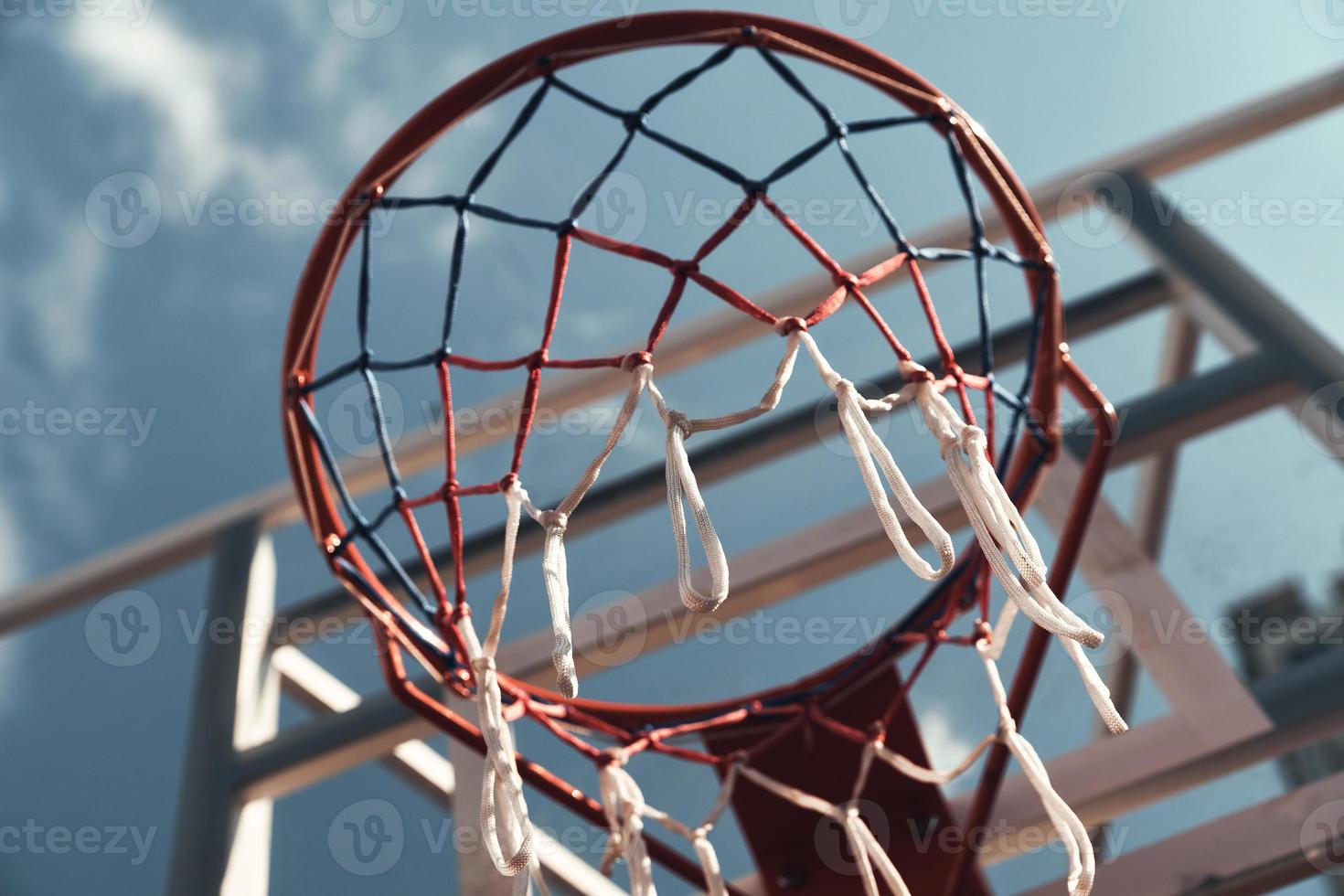 Best game ever. Shot of basketball hoop with sky in the background outdoors photo