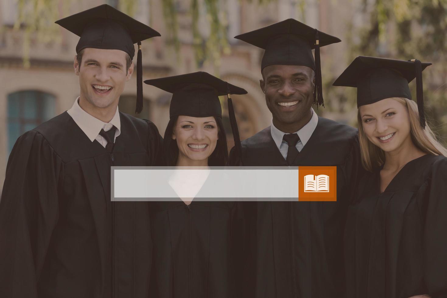 Happy graduation. Four college graduates in graduation gowns standing close to each other and smiling photo