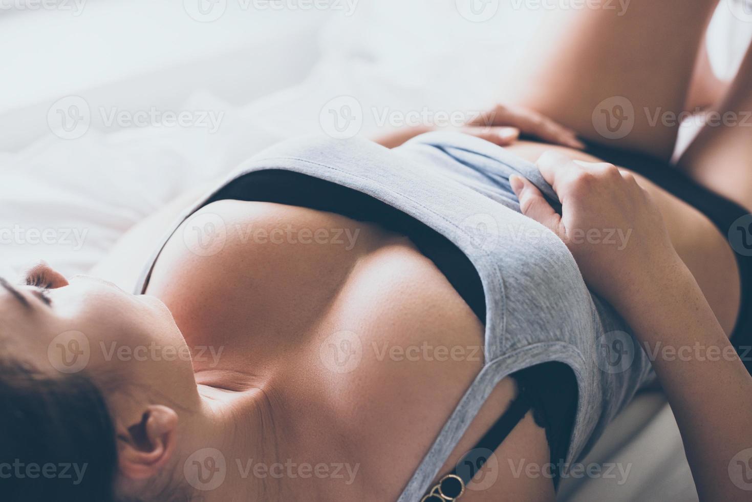 Time to wake up Beautiful young woman in black lingerie and tank top  looking at camera while lying in bed 13572801 Stock Photo at Vecteezy