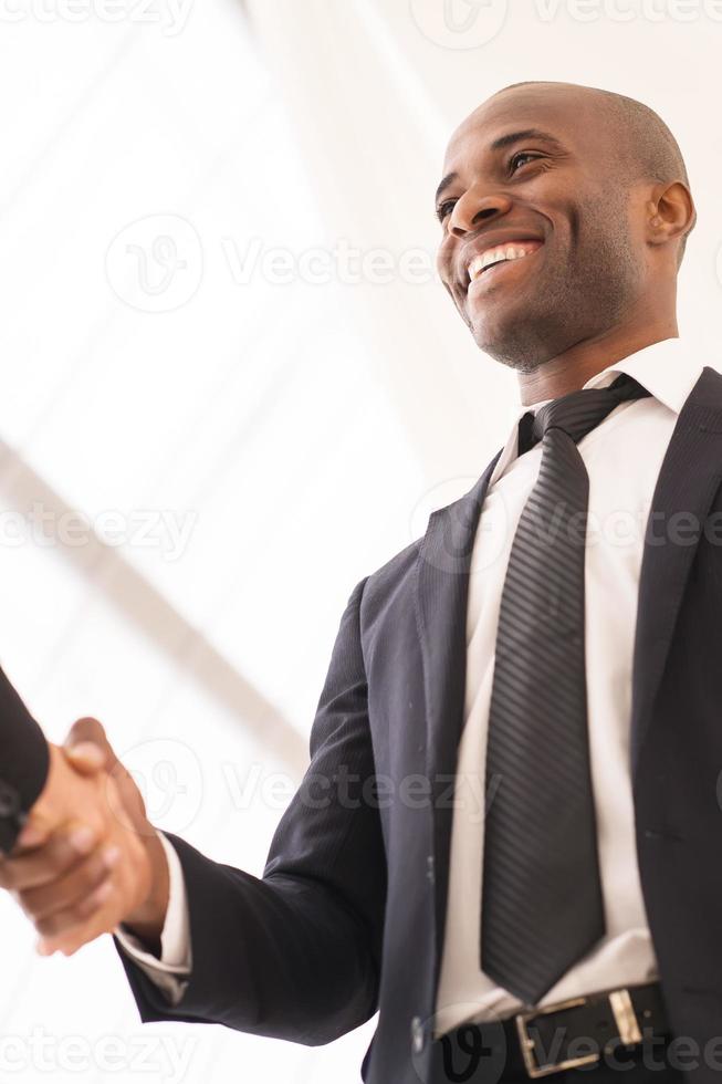 Good deal. Close-up of low angle view of business men shaking hands photo