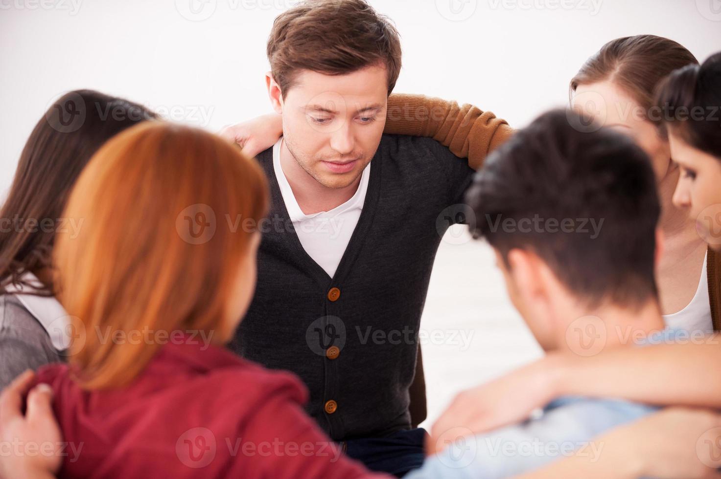 Together we are strong. Group of people sitting in circle and bonding to each other photo