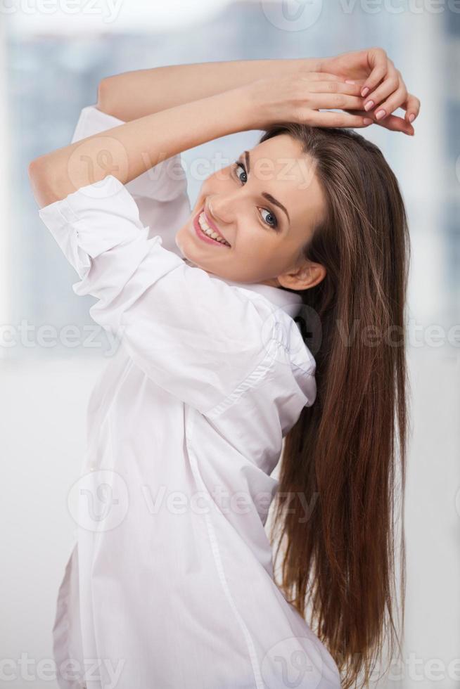 Cheerful beauty. Beautiful young woman in white shirt holding hand on chin  and smiling while isolated on white 13526122 Stock Photo at Vecteezy