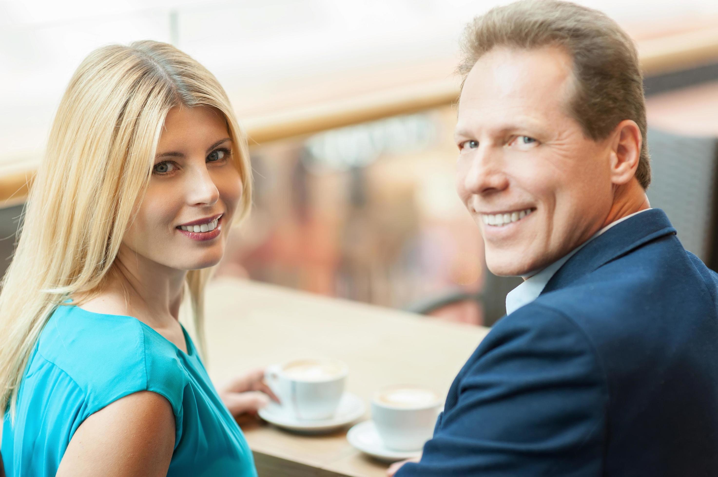 couple-drinking-coffee-walking-stock-photo-2145325947-shutterstock