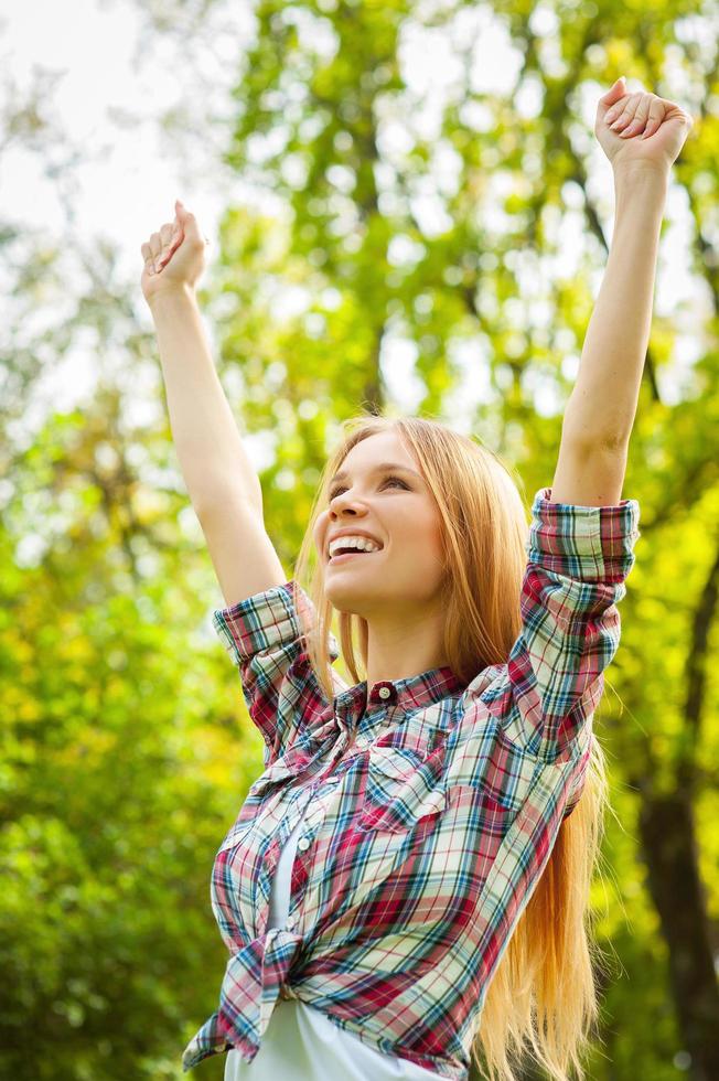 Enjoying spring day. Playful young woman having fun in nature photo