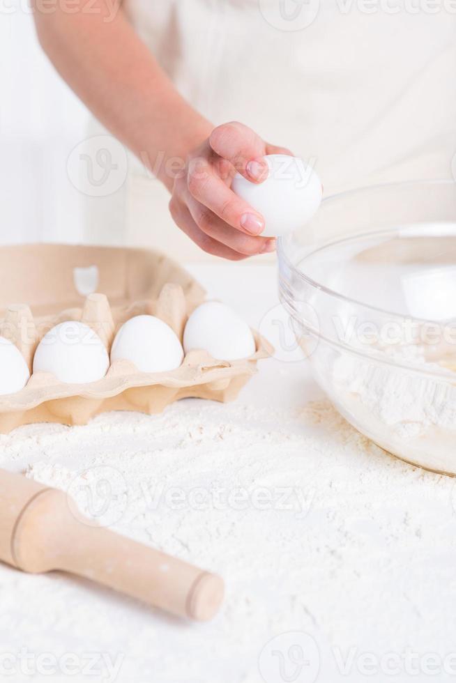 Cracking an egg. Closeup of woman cracking egg for pastry 13536296