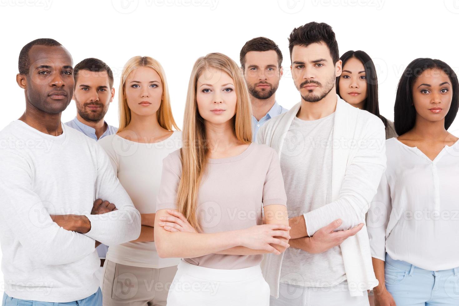 Confident business team. Group of confident multi-ethnic group of people in smart casual wear looking at camera while standing against white background photo