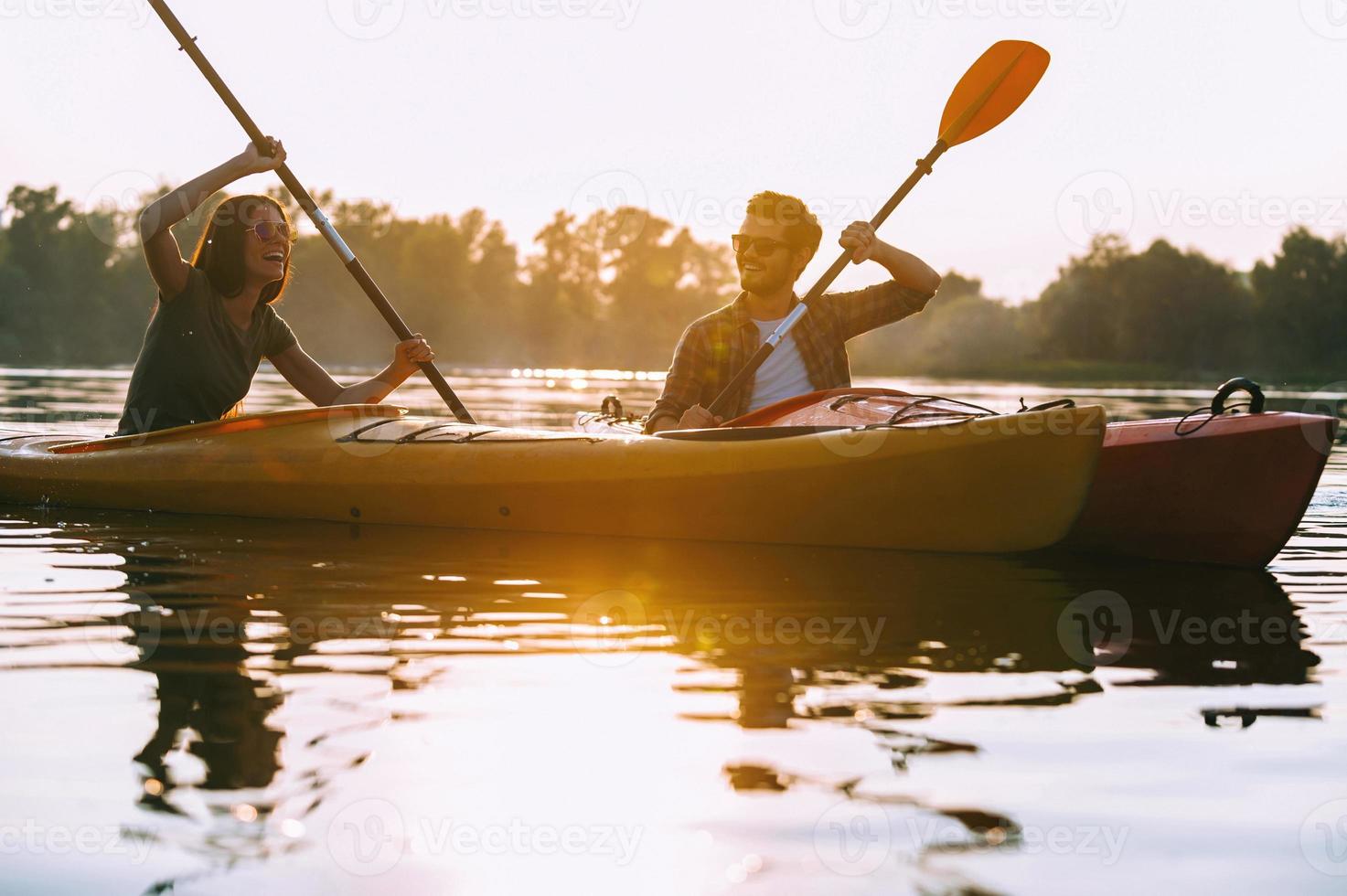 Kayaking together is fun. Beautiful young couple kayaking on lake