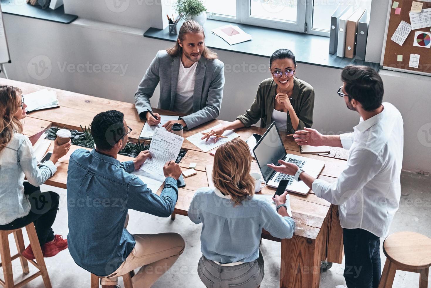 Ready to work hard. Top view of modern young people discussion business while working in the office photo