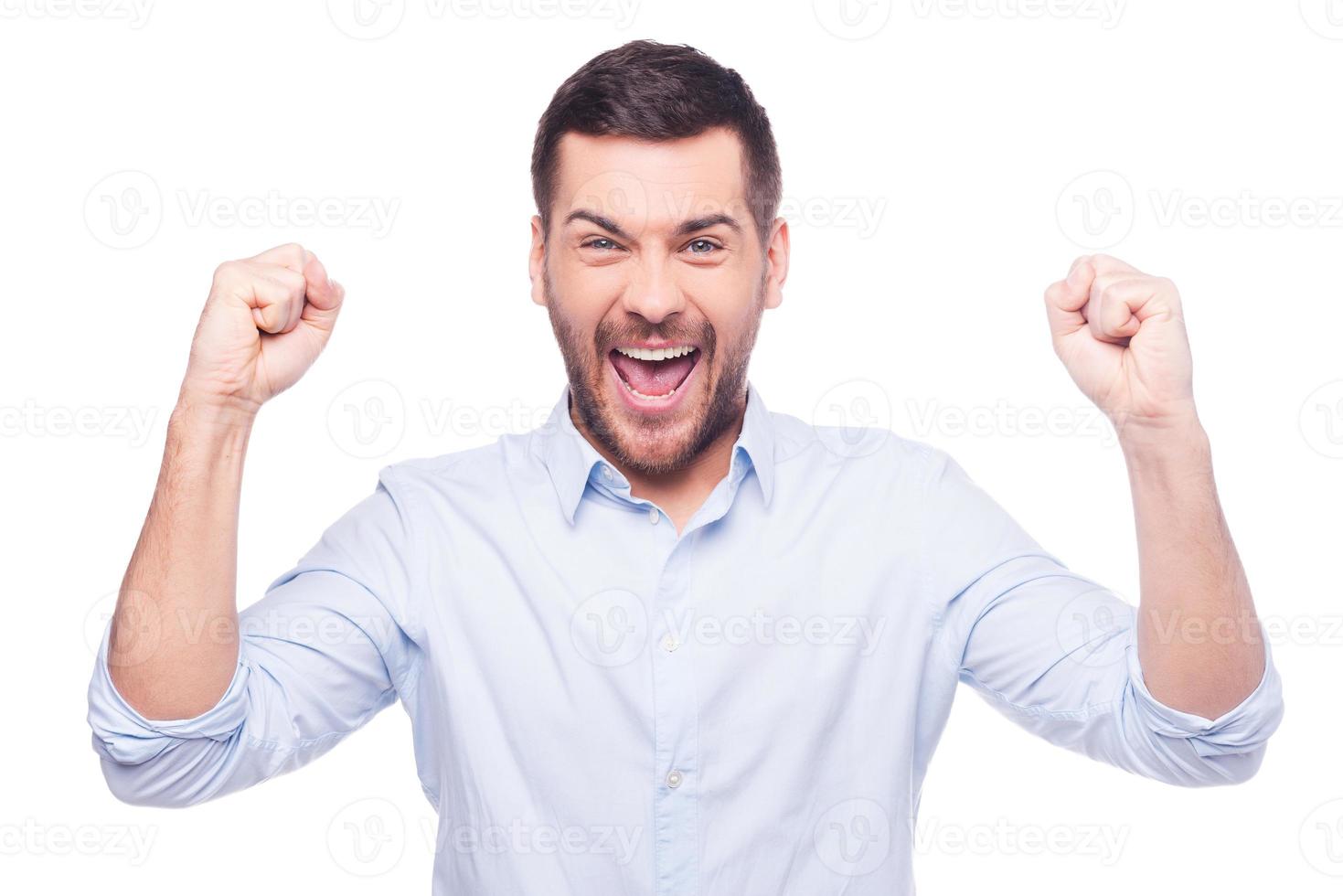 Successful businessman. Happy young man in formalwear gesturing and smiling while standing against white background photo