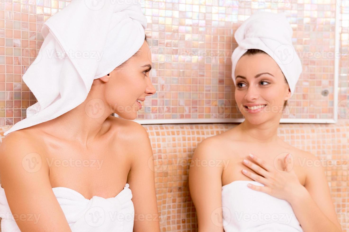 Attractive And Smiling Woman In Towels Looking At Camera In Sauna