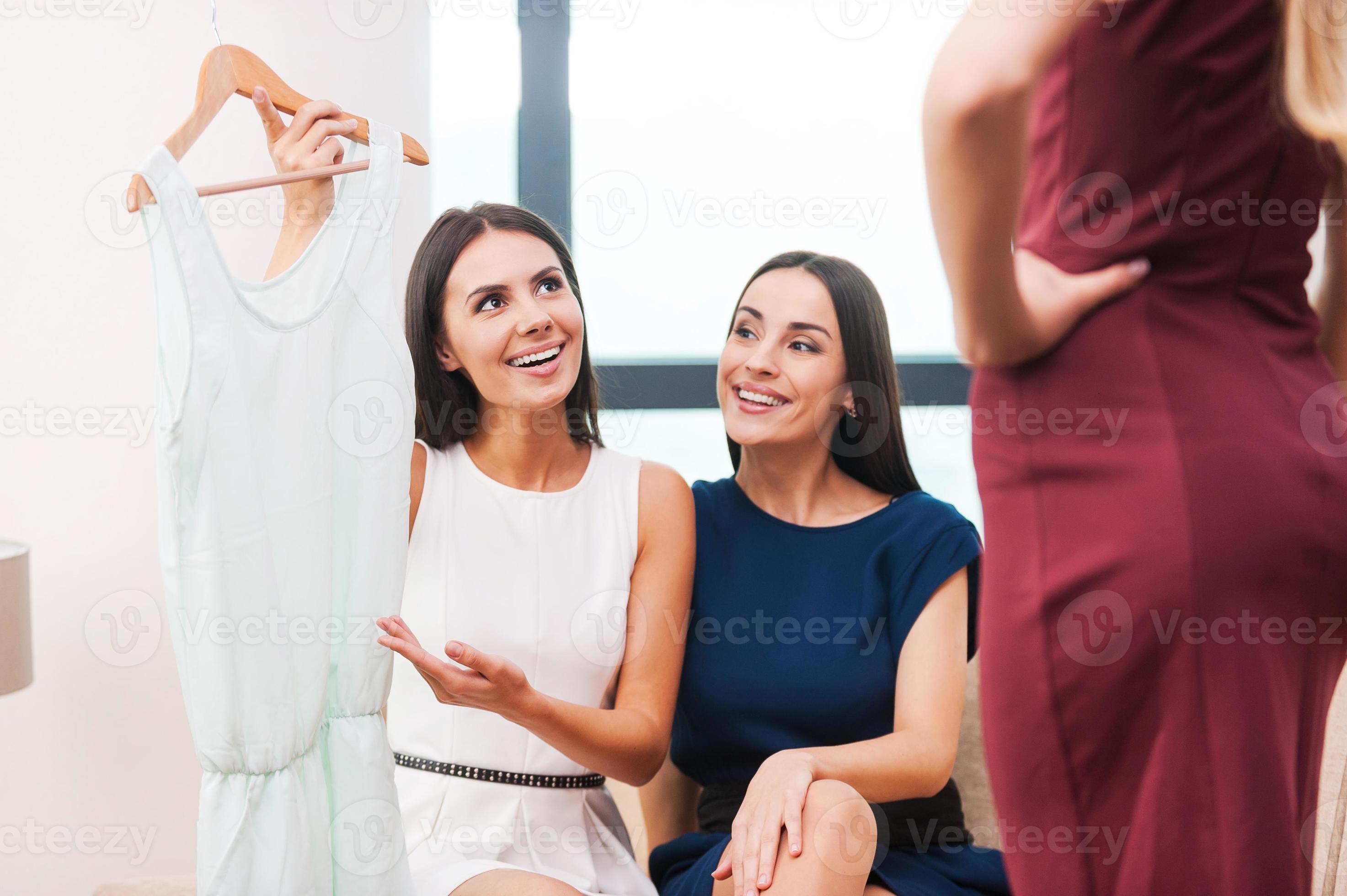 Try this one Two beautiful young women in evening gowns holding dress ...