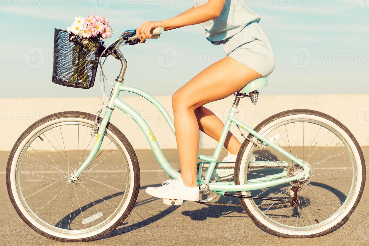 What a beautiful scenery Smiling young couple riding on bicycle while man pointing away photo