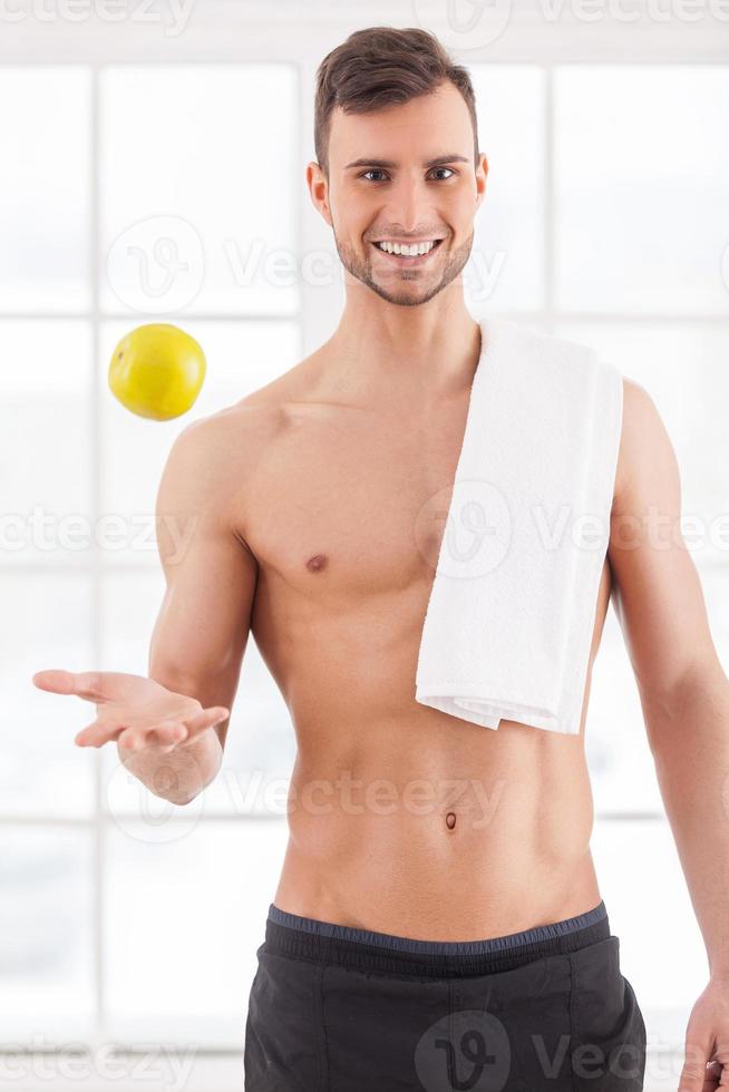Premium Photo  Muscular man posing in the gym with a towel on his  shoulders. fitness concept.