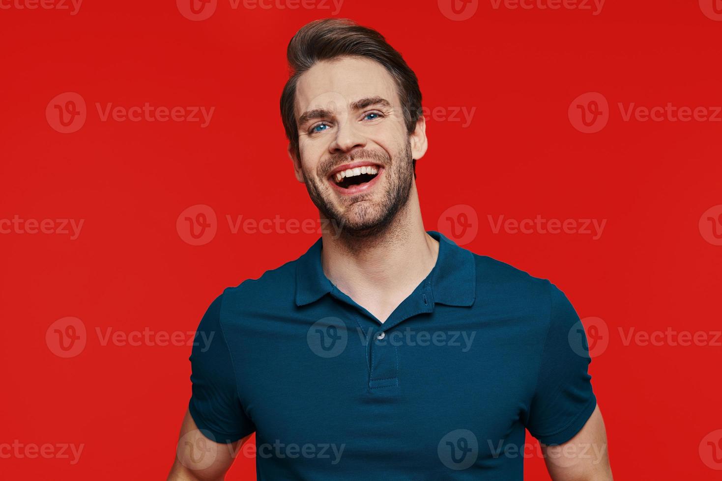 Portrait of handsome young man in casual wear looking at camera and smiling photo