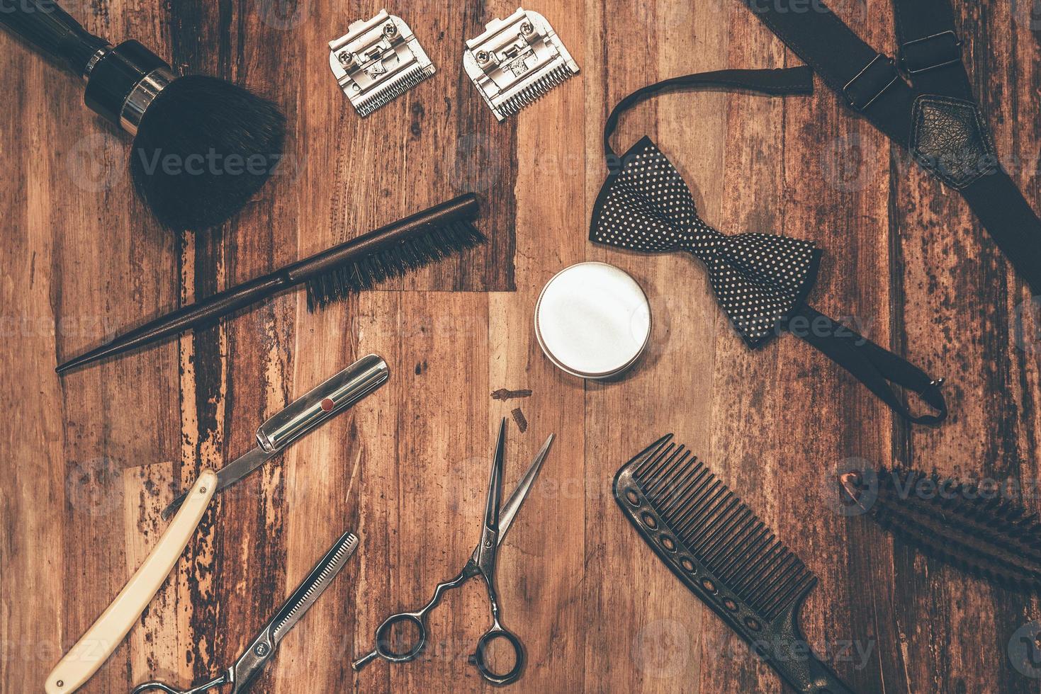 Barber tools. Top view of barbershop tools and men accessories lying on the wood grain photo