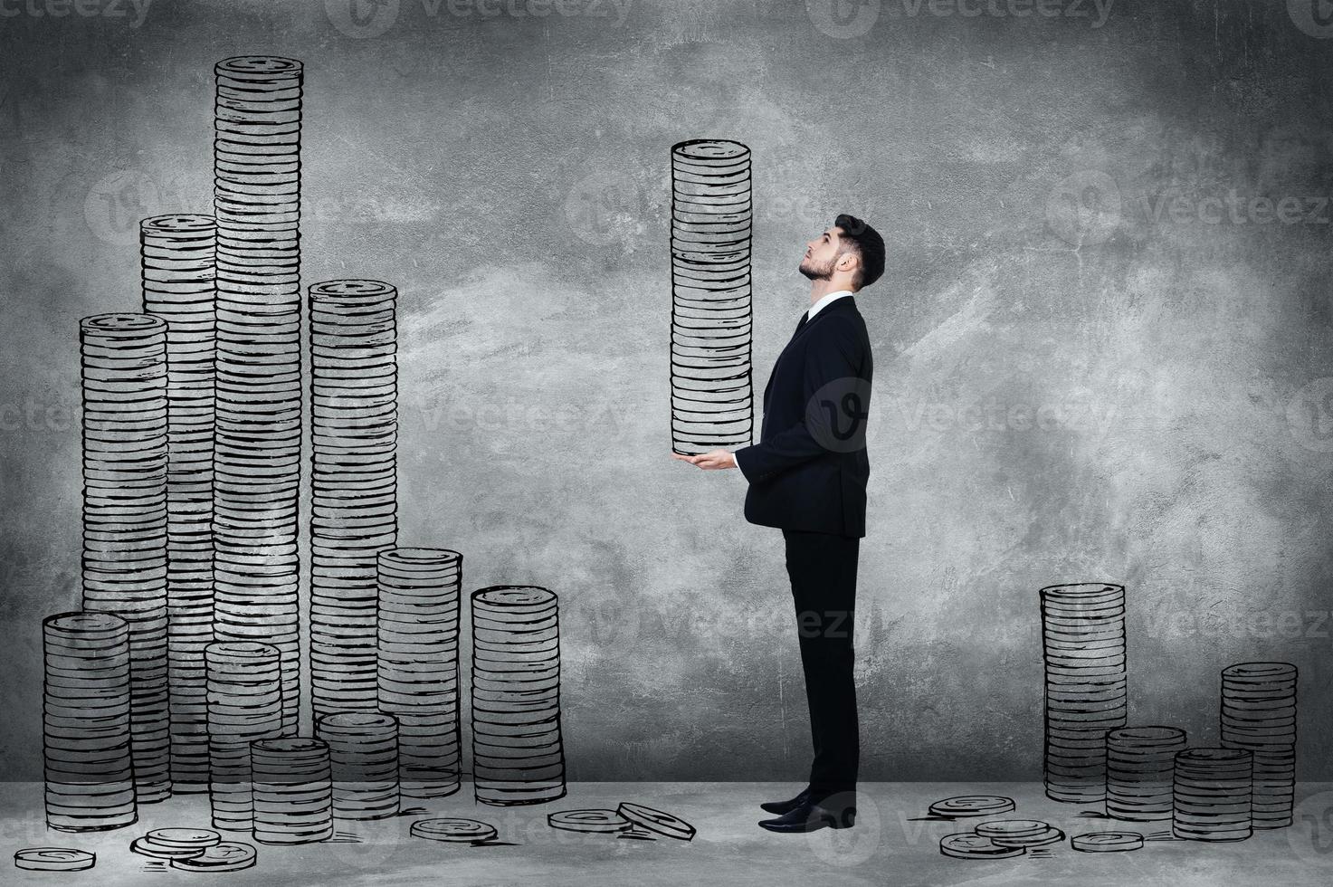 Just making money. Full length of confident young man in full suit carrying illustrated coin stack while standing against concrete wall photo