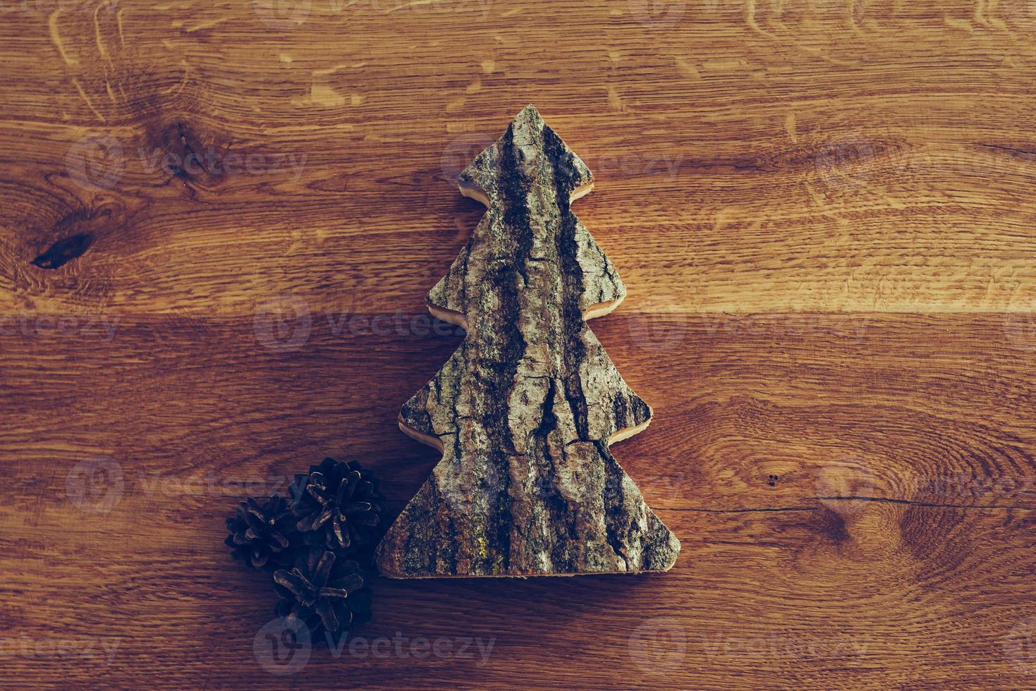 Handmade tree. Close-up top view of handmade Christmas tree lying on the rustic wooden grain photo