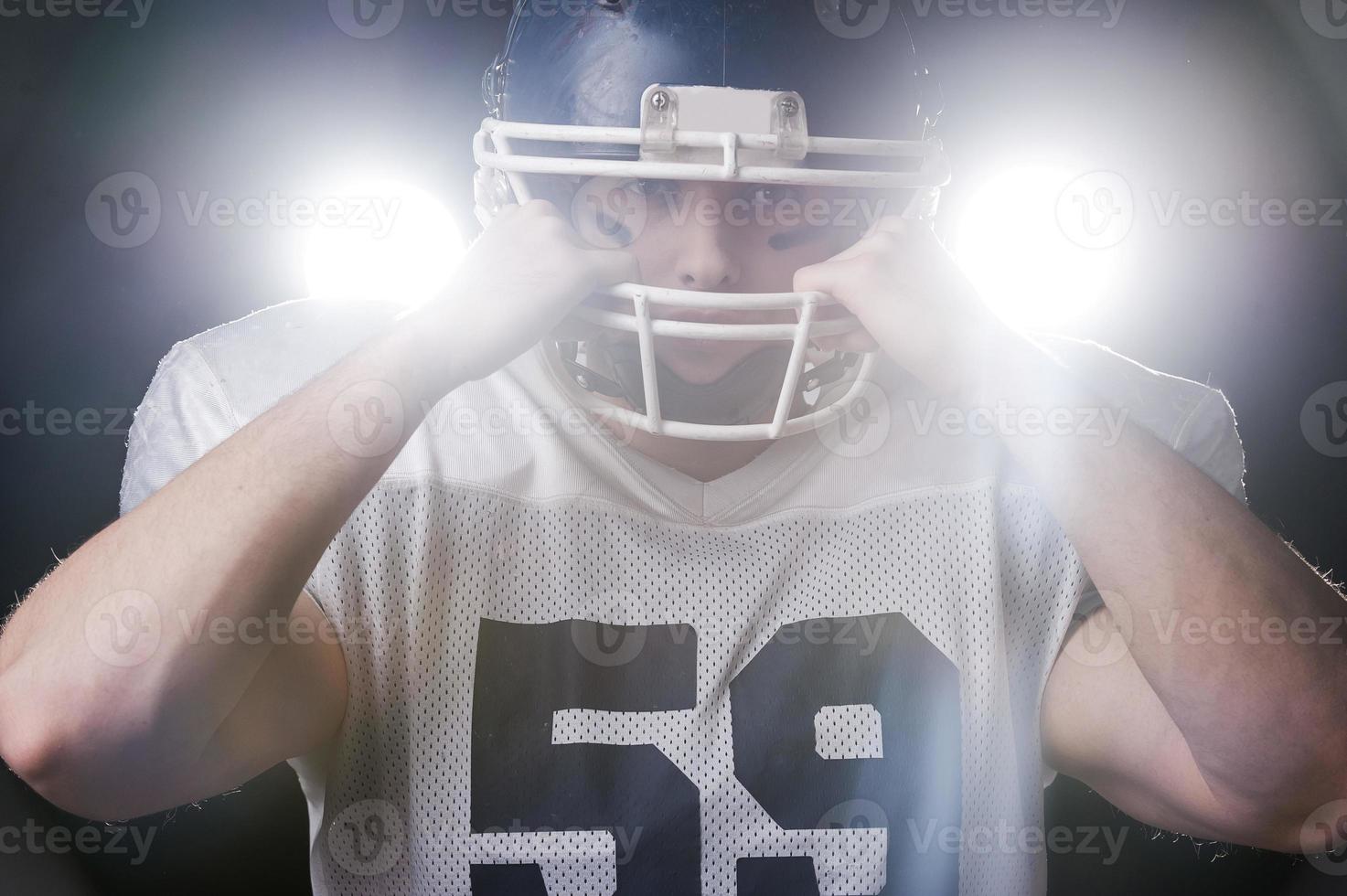 Football Player Holding Football With Both Hands Stock Photo