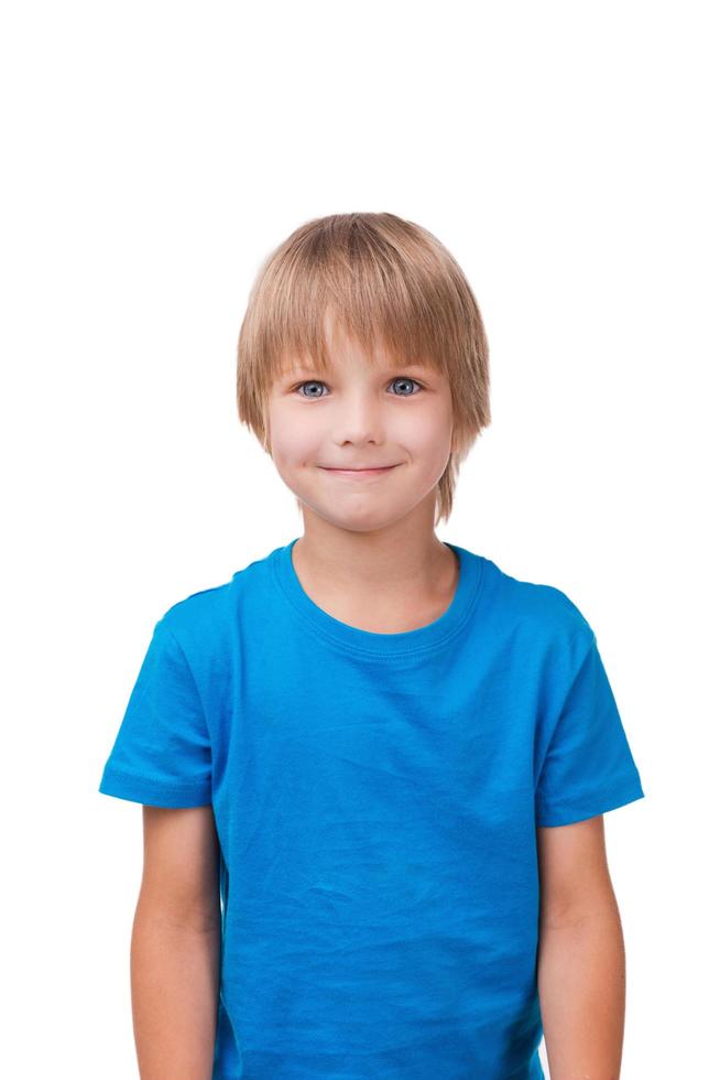 Cute little boy. Cheerful little boy looking at camera and smiling while standing isolated on white photo