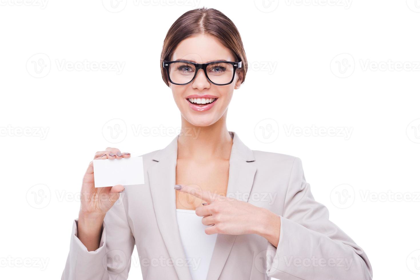 Copy space on her card. Confident businesswomen holding card and looking at camera while standing against white background photo