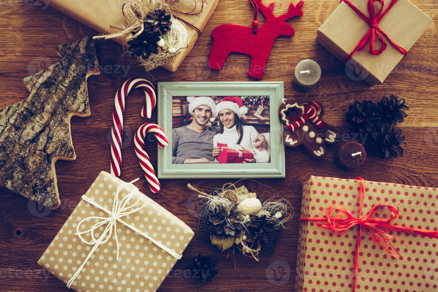 Bright memories. Top view of Christmas decorations and photograph in picture frame laying on the rustic wooden grain photo