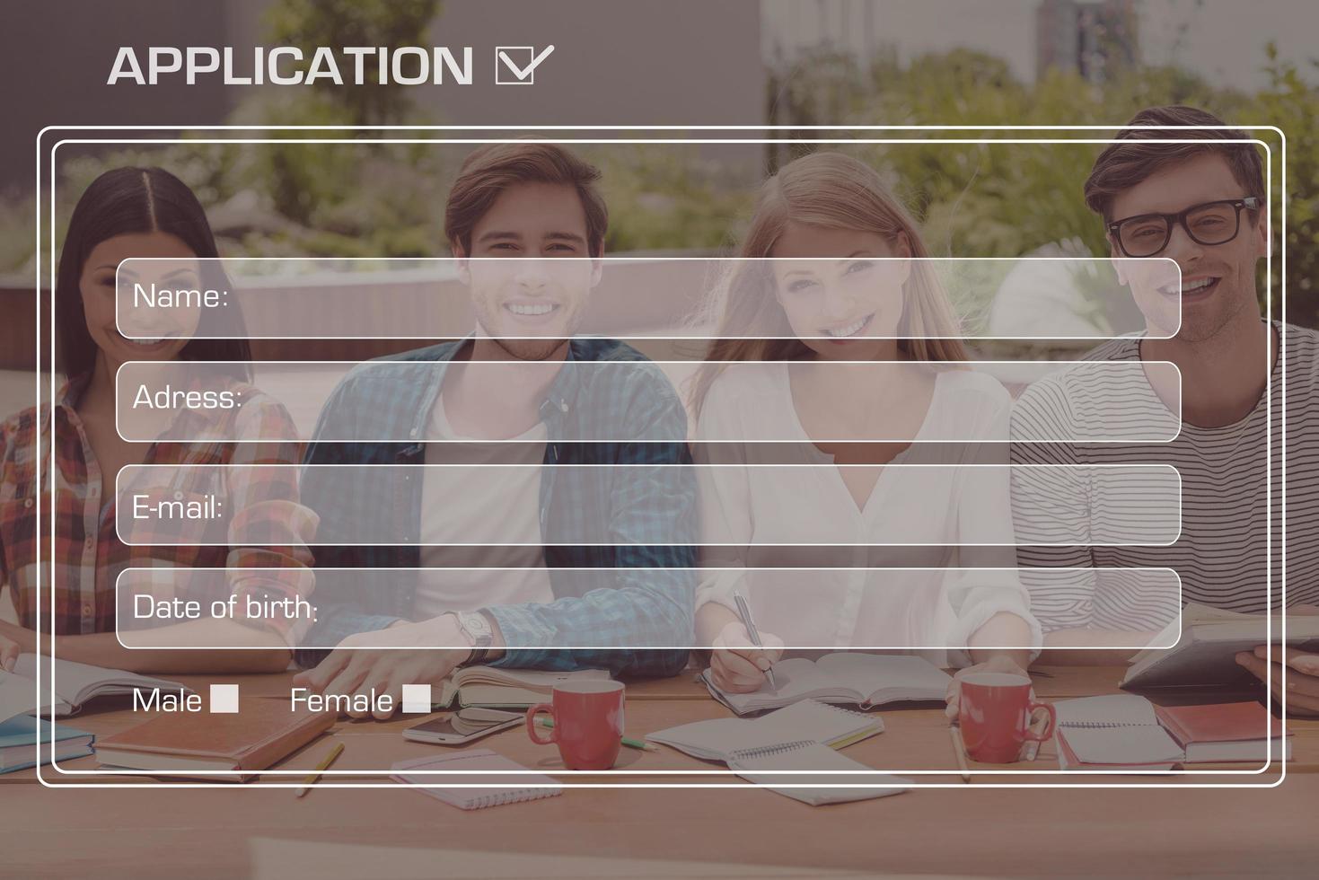 College application. Picture of four cheerful students sitting at the desk outdoors with digitally composed application form over it photo