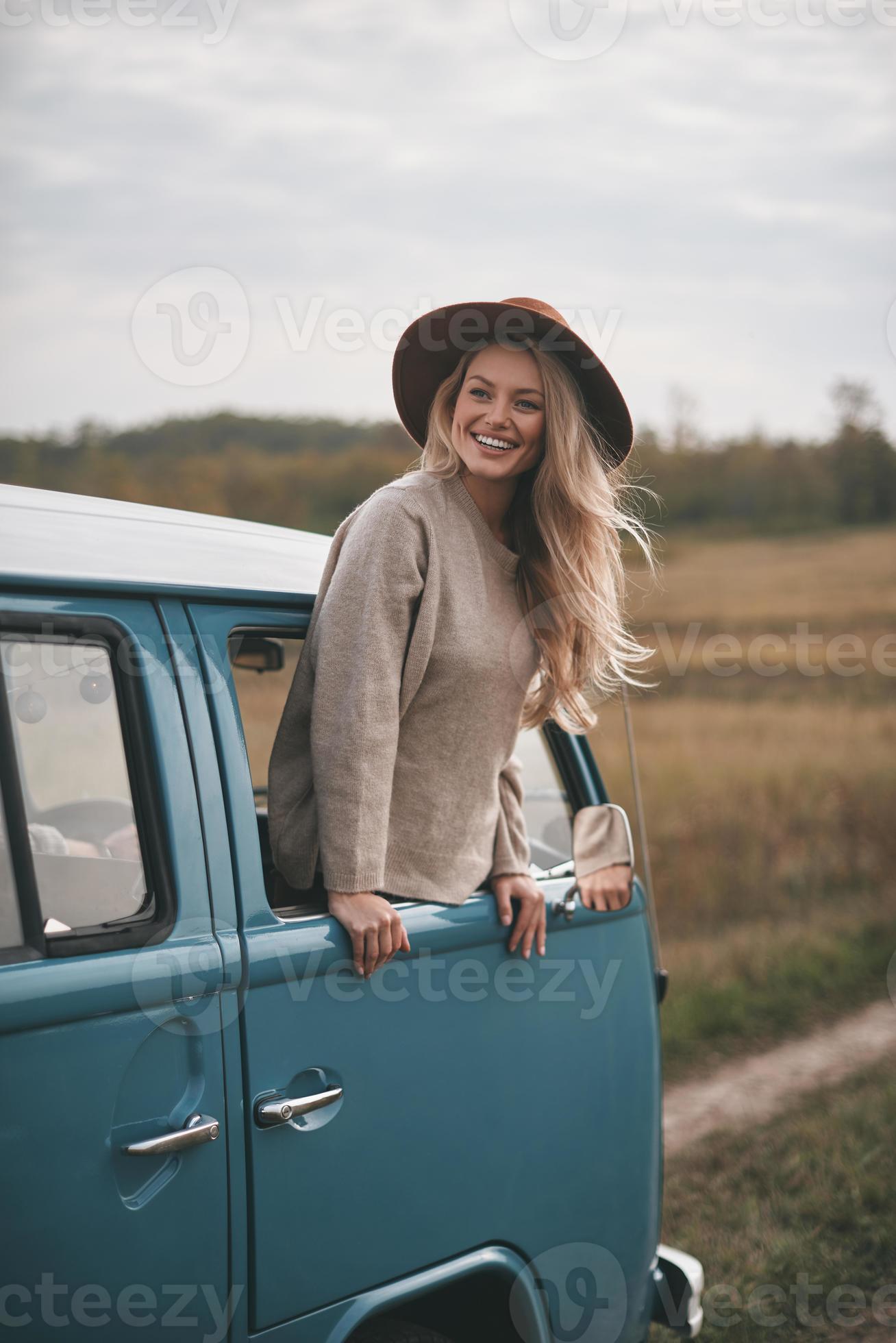 Life is awesome Attractive young smiling woman leaning out the vans