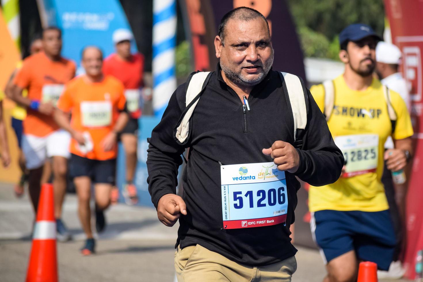 New Delhi, India - October 16 2022 - Vedanta Delhi Half Marathon race after covid in which marathon participants about to cross the finish line, Delhi Half Marathon 2022 photo