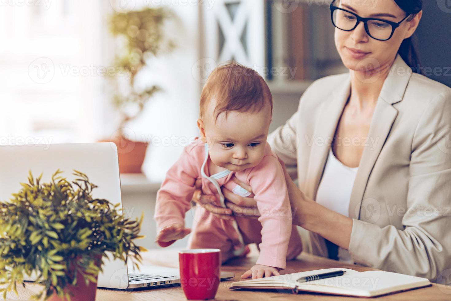 Let me examine your working place Little baby girl looking away while crawling on her mothers place of work photo