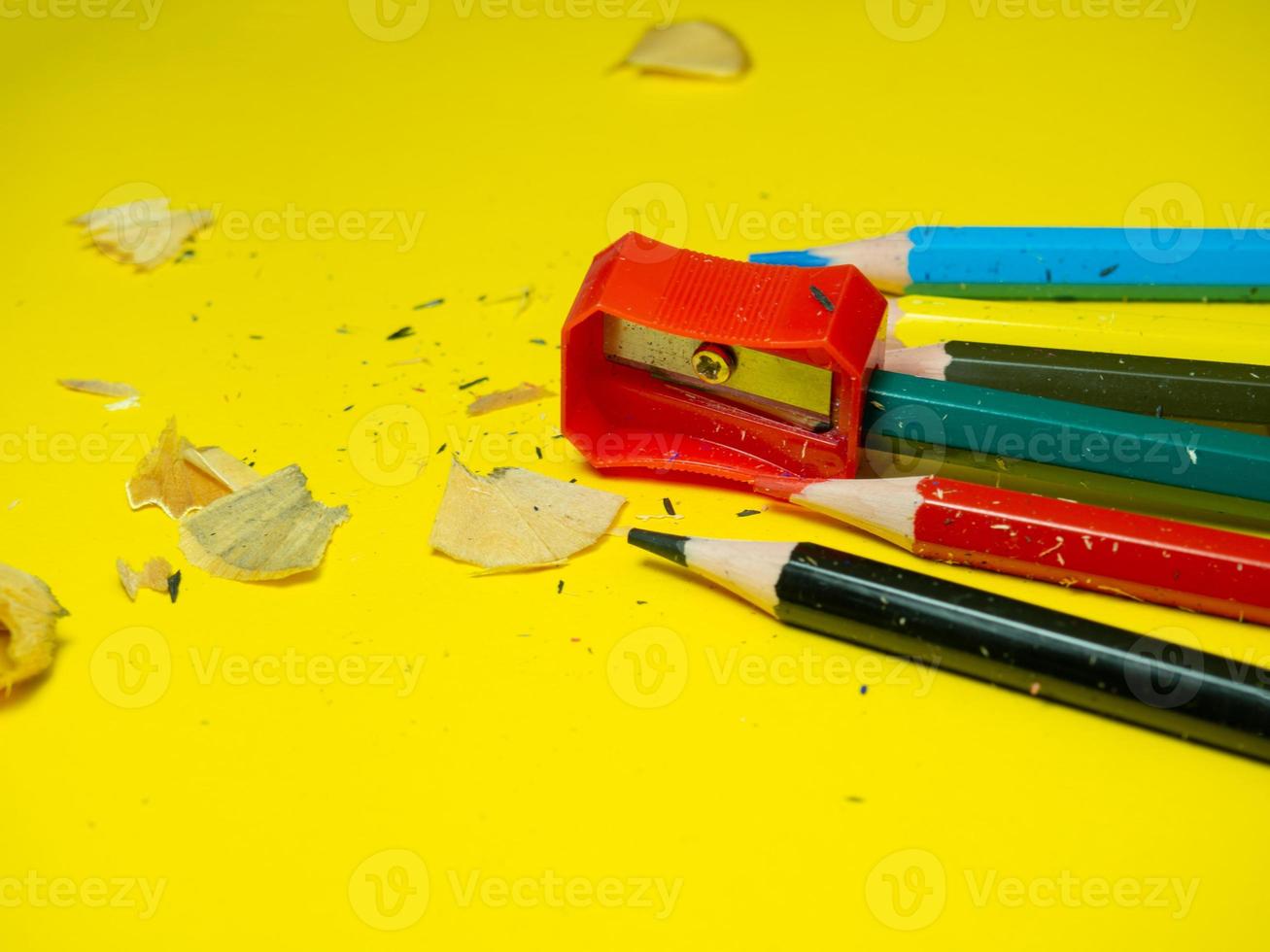 School supplies.  Pencil sharpener . Multicolored pencils. Wood shavings. The process of preparing for work. Creative mess photo
