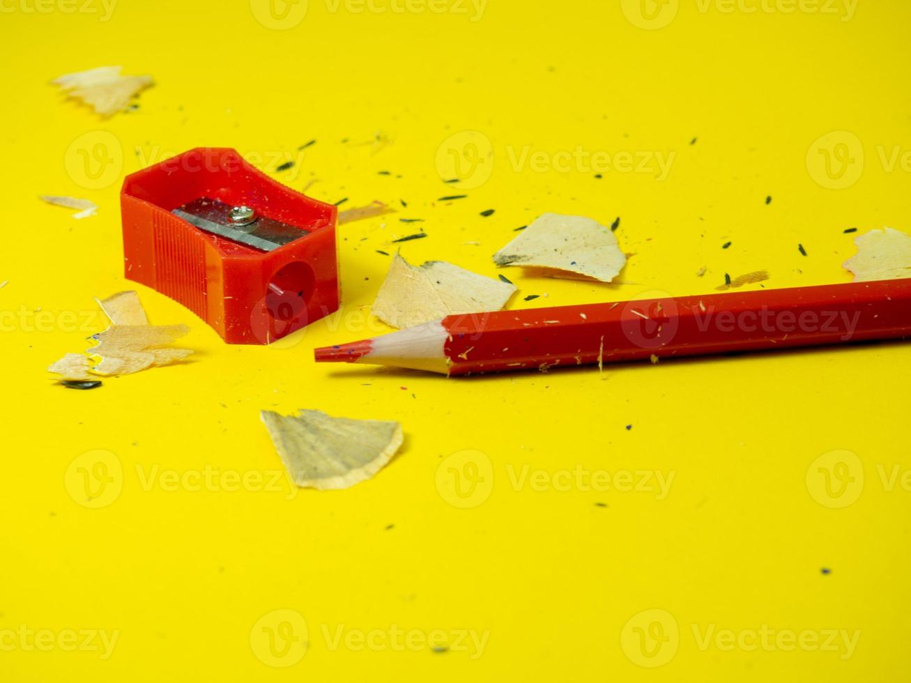 School supplies.   Pencil sharpener . Red pencil. Wood shavings. The process of preparing for work. Creative mess photo
