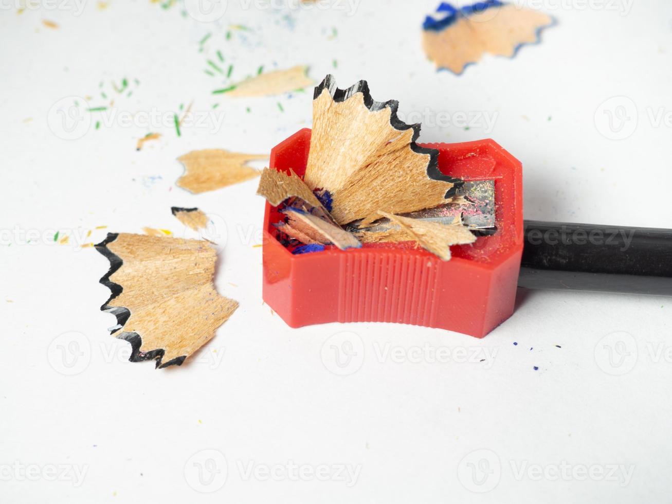 School supplies. Pencil sharpening. Pencil sharpener . Black pencil. Wood shavings. The process of preparing for work. Creative mess photo