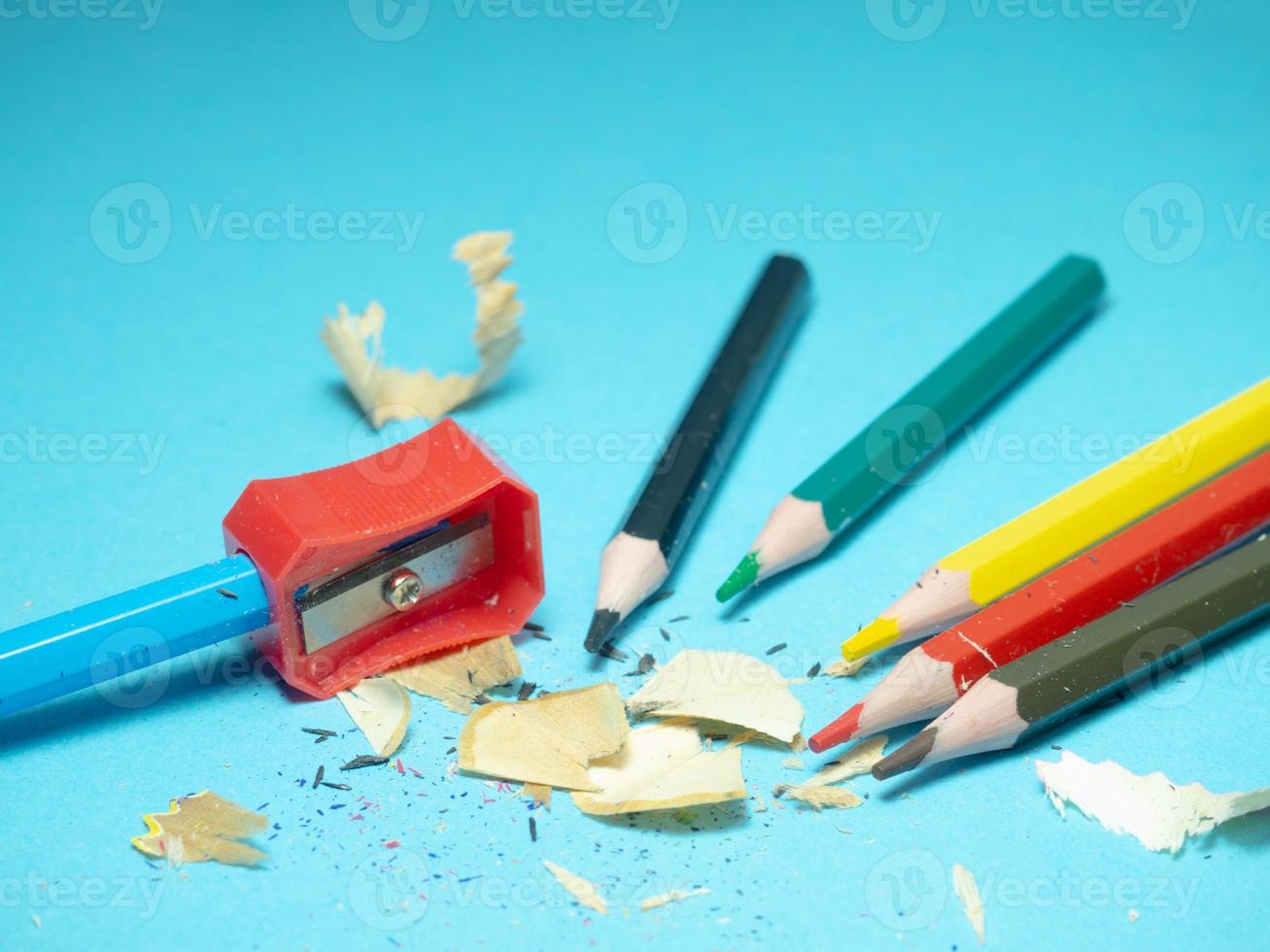 School supplies. Pencil sharpening. Pencil sharpener . Multicolored pencils.   The process of preparing for work. Creative mess photo