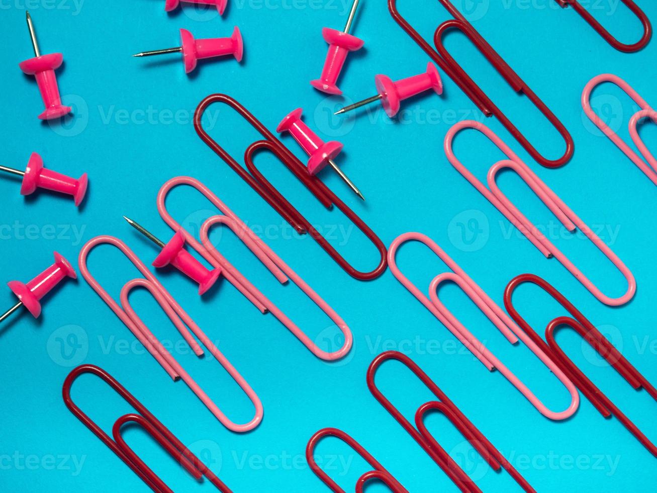 Office work. Colored paper clips. Colored paper with staples.  Colorful office supplies. photo