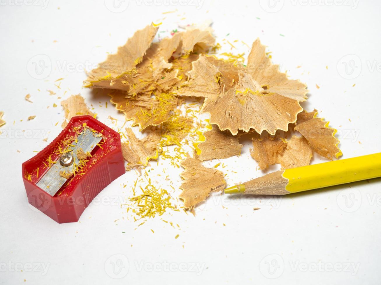 Artist's workshop. School supplies.   Multicolored pencils. Wood and graphite shavings. The process of preparing for work. Creative mess photo