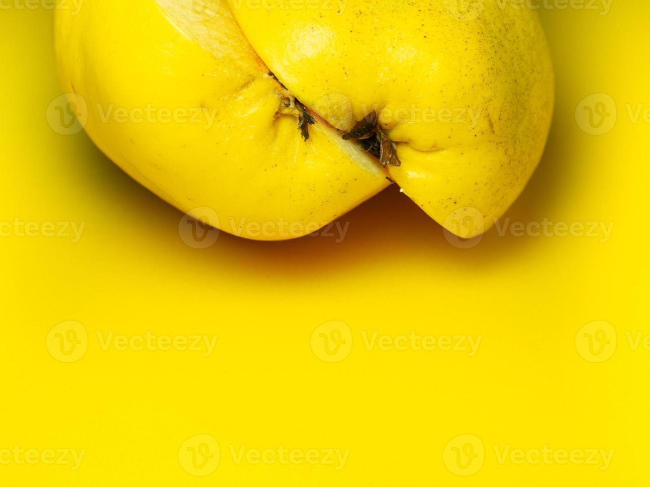 Juicy quince. Fruit on a yellow background. Ripe useful product. photo