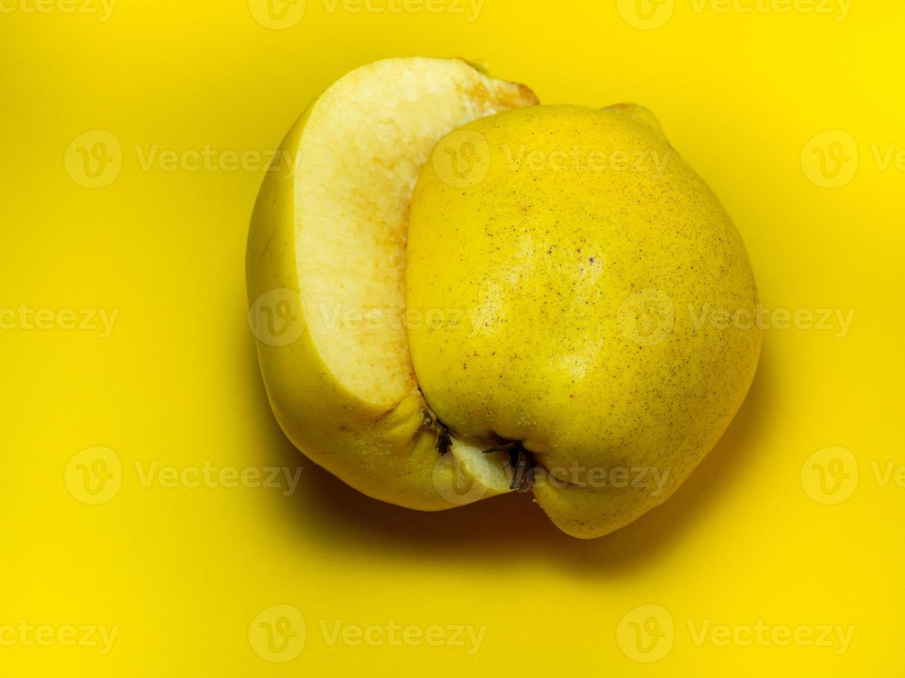 Juicy quince. Fruit on a yellow background. Ripe useful product. photo