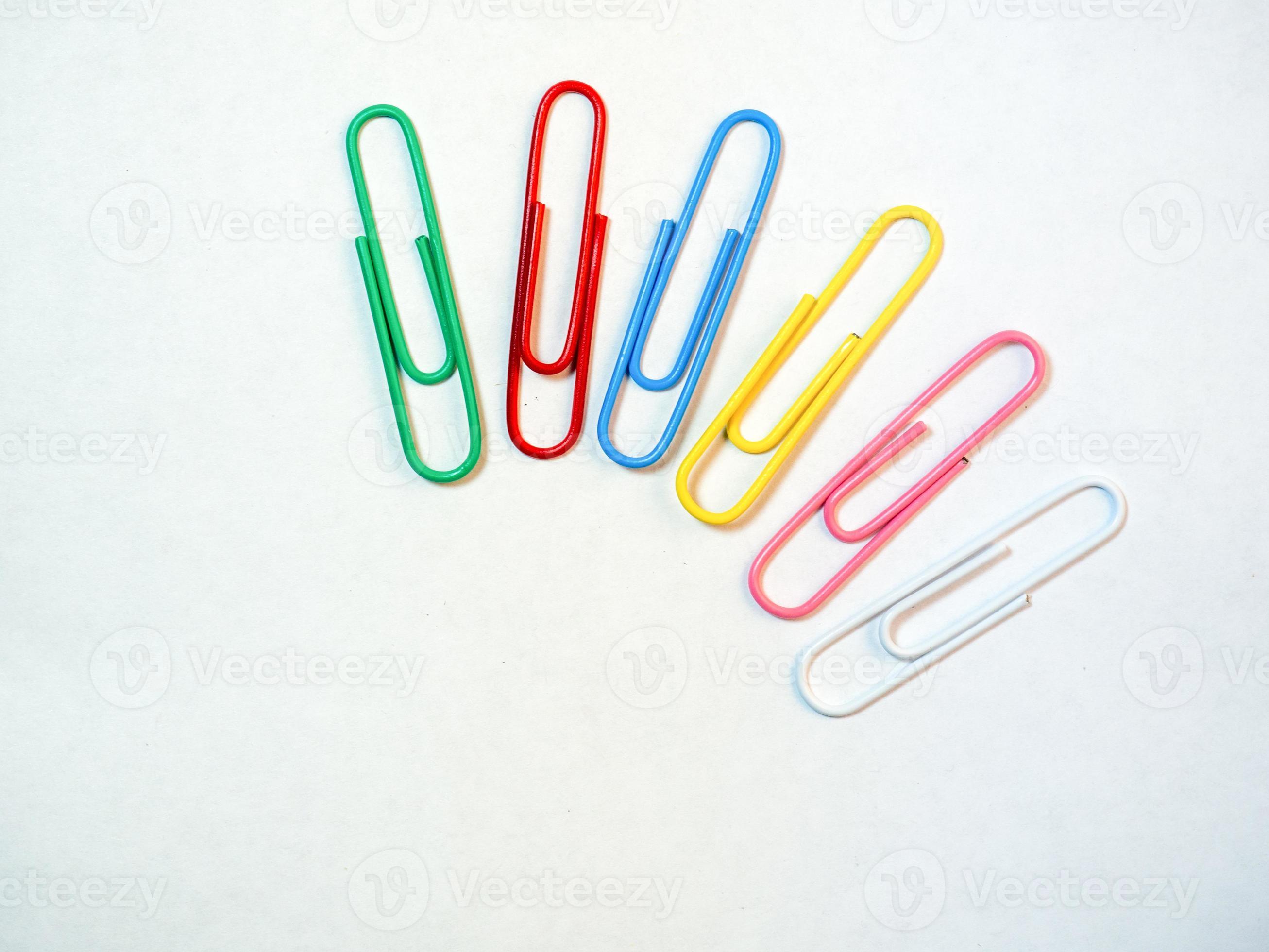 Large multicolored paper clips. Paperclip of documents. Desktop