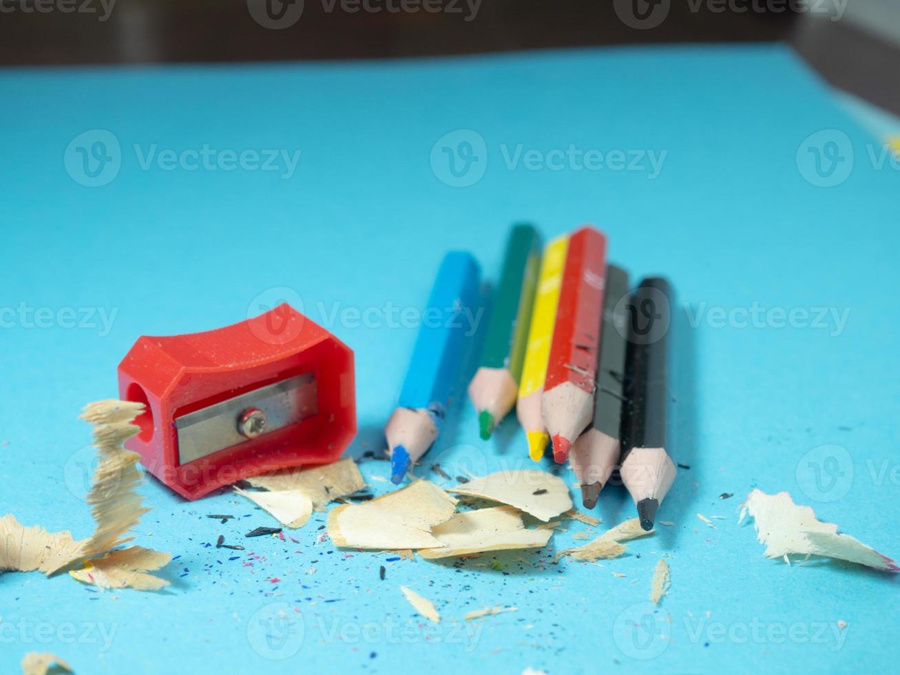 School supplies. Pencil sharpening.  Multicolored pencils. Wood shavings. The process of preparing for work. Creative mess photo