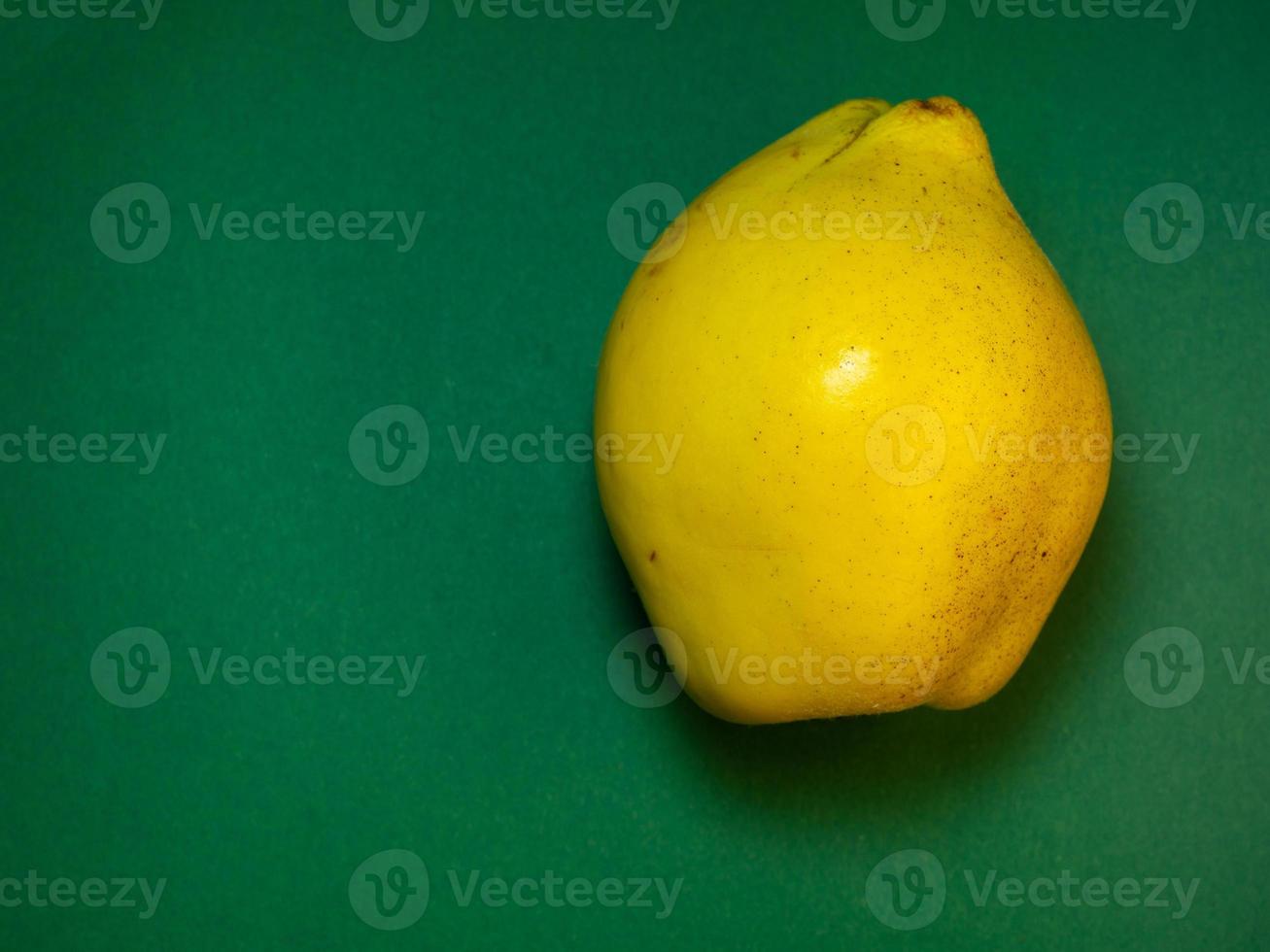 Juicy quince. Fruit on a green background. Ripe useful product. photo