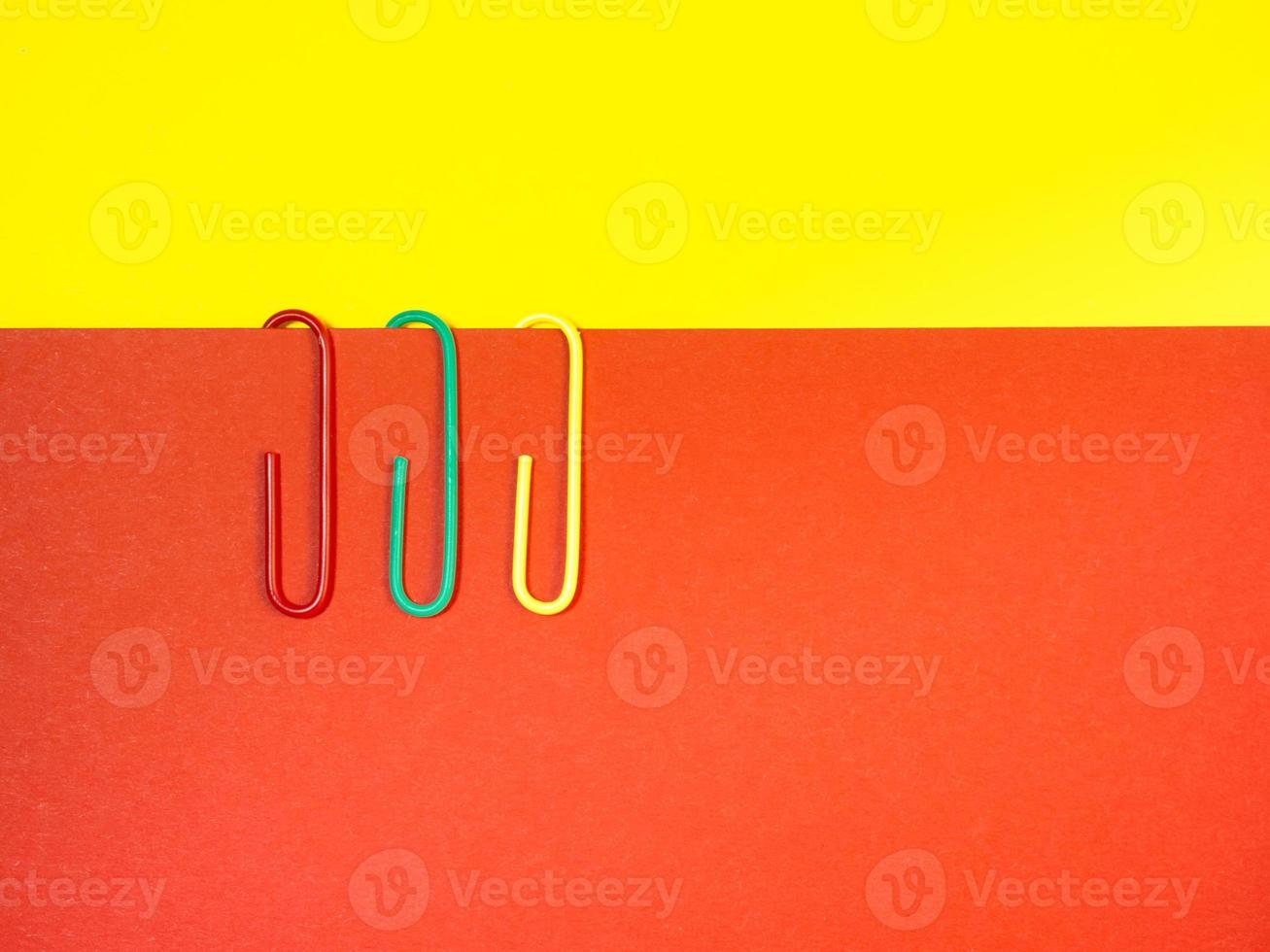 Large multi-colored paper clips. Paperclip of documents. Desktop. photo