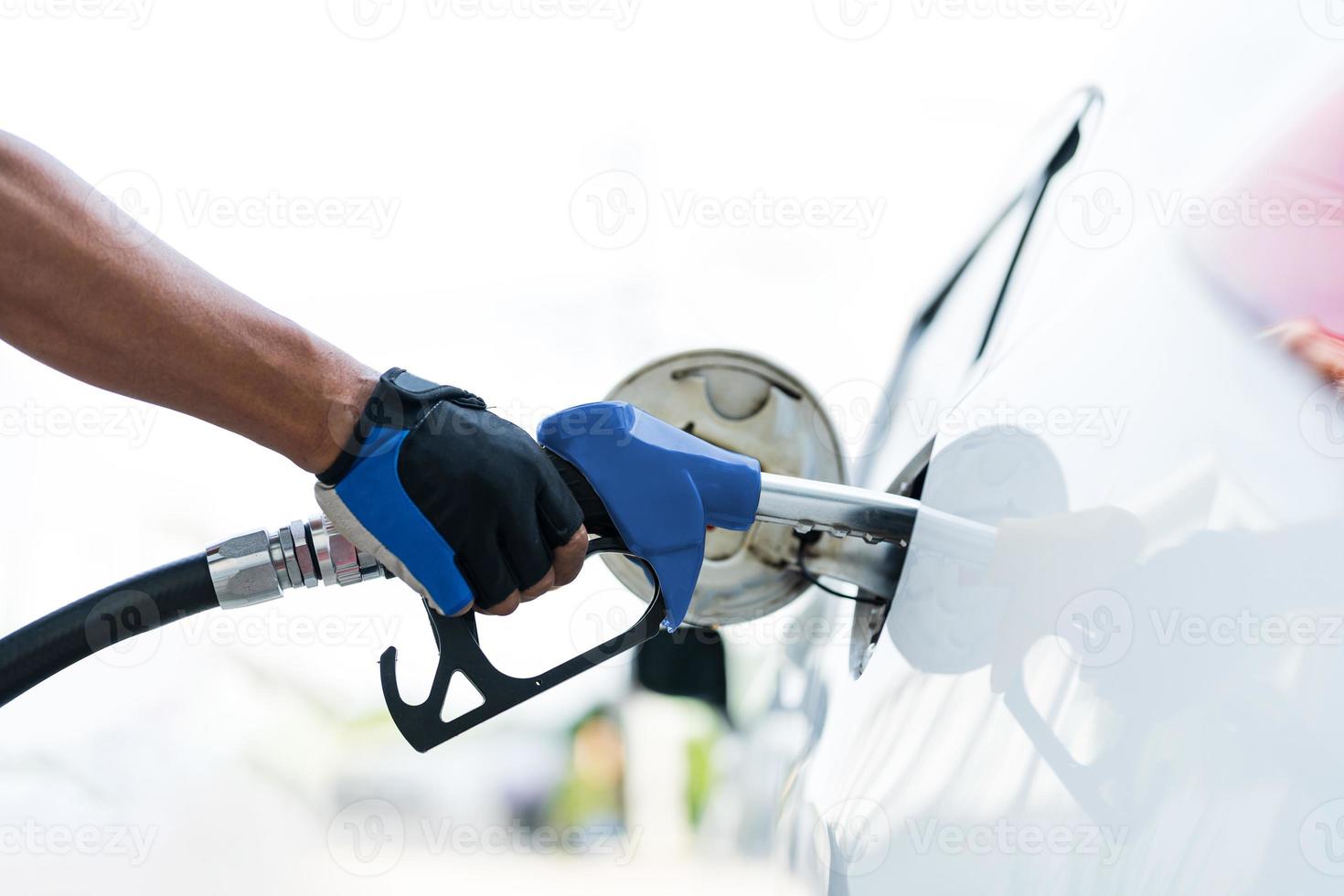 Filling car with gas fuel at station pump photo