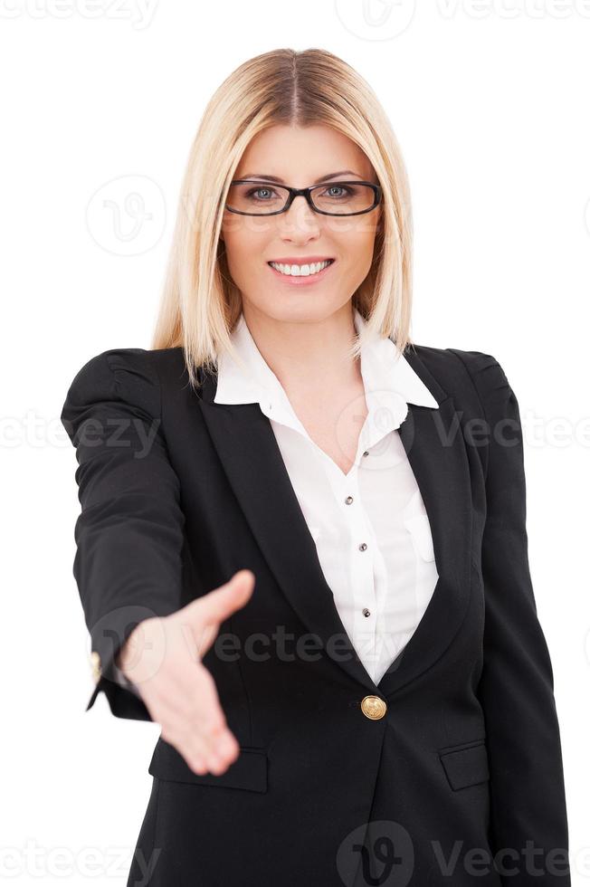 Congratulations Confident mature businesswoman stretching out hand for shaking and smiling while standing isolated on white photo