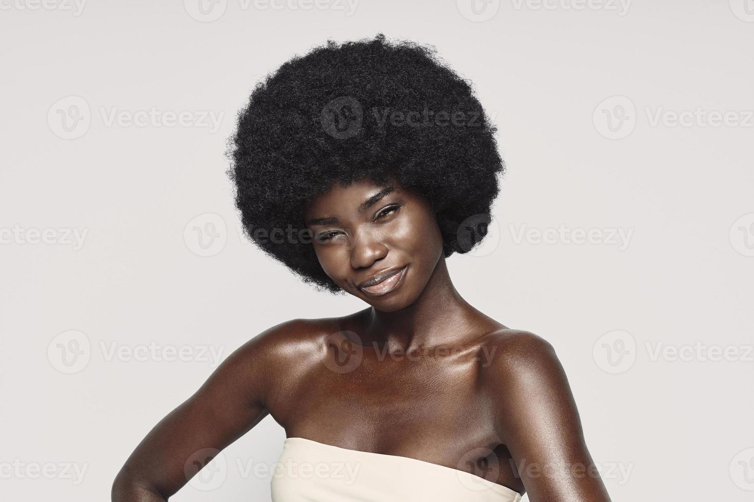 Portrait of beautiful young African woman looking at camera and smiling photo