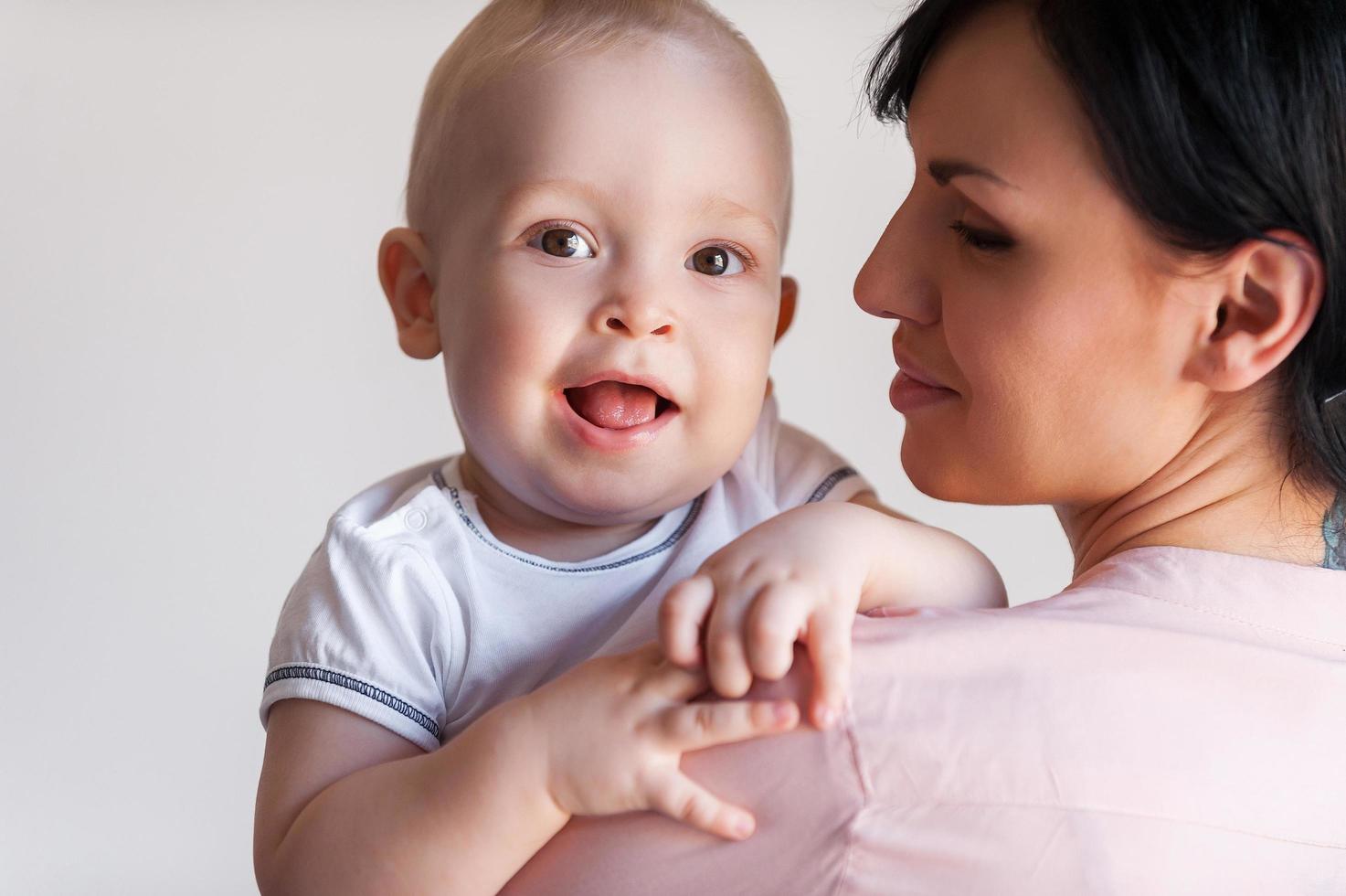 madre y bebe vista trasera, de, madre, tenencia, ella, sonriente, bebé foto