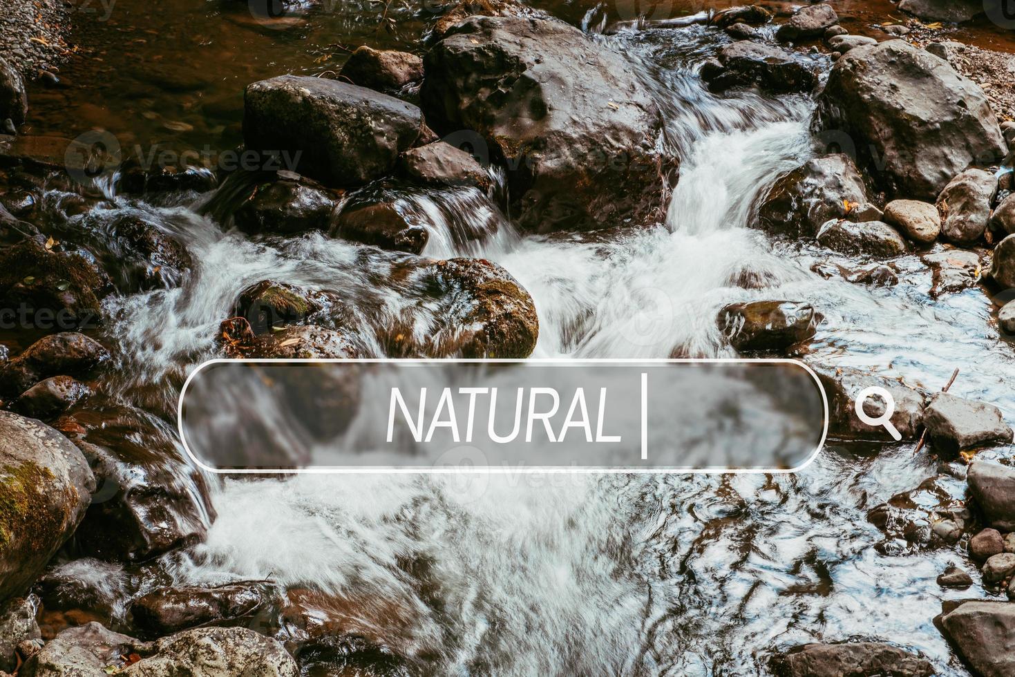 Choose natural. Close-up of falling clean water with rocks and stones photo